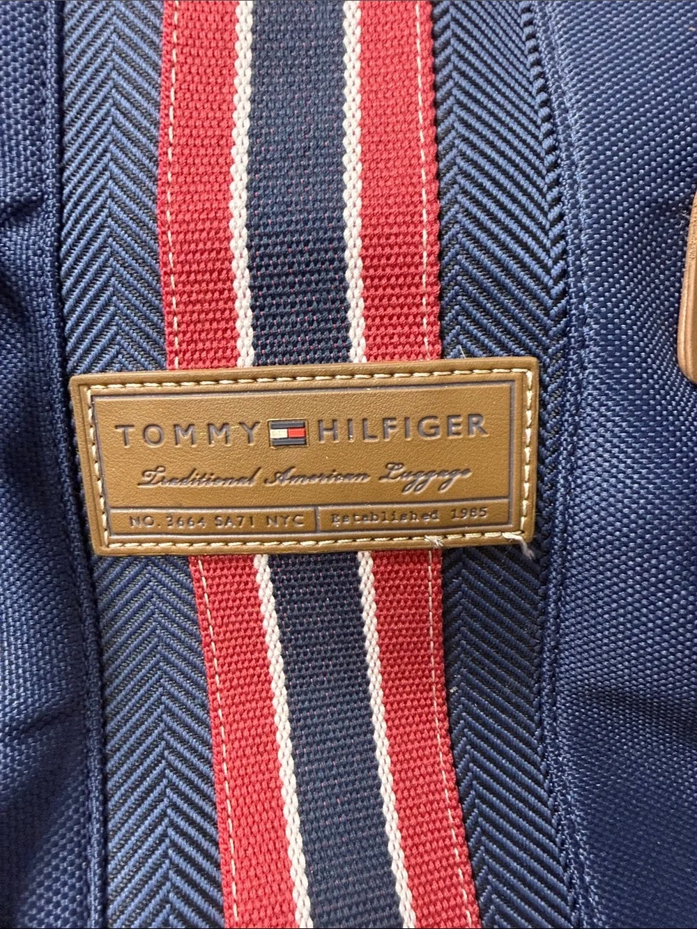 Tommy Hilfiger Navy rolling Duffel with Red & White Center Stripe  carry on